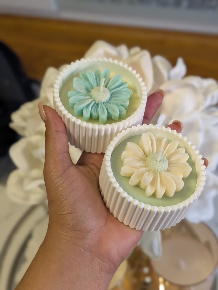 Fluted candles decorated with dried flowers on a pastel surface, photo 2