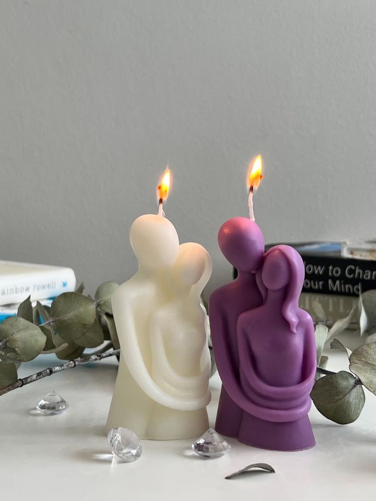 Ivory sculptural candle of two figures arranged beside a vase, photo 3
