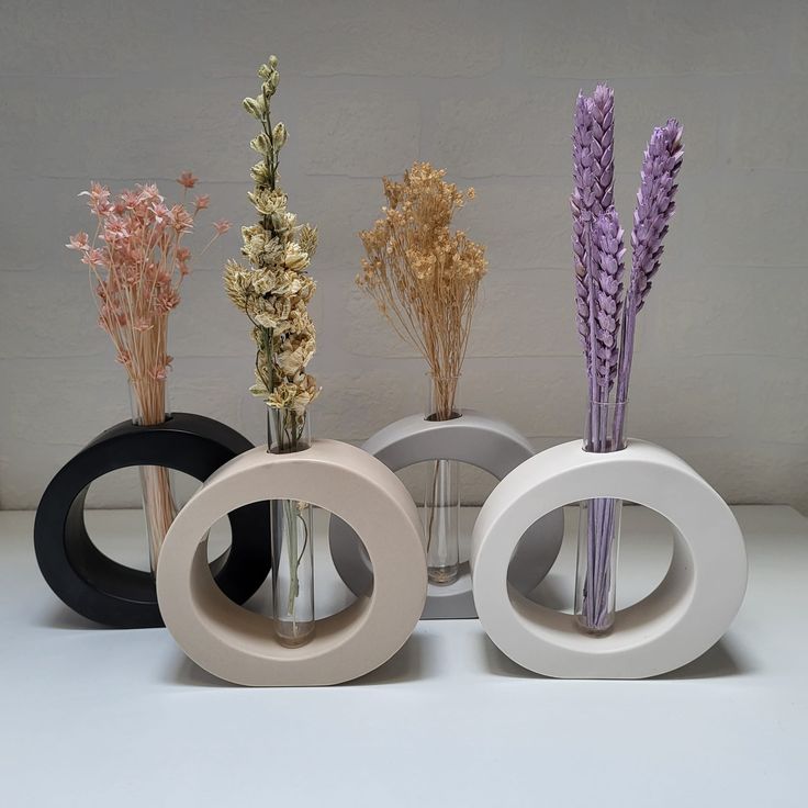 Sculptural ring vases in black, blush, grey and white with dried flowers
