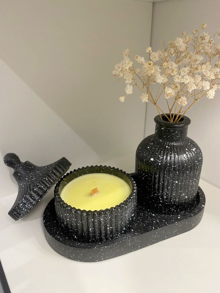 Dark speckled fluted candle holder and vase on a matching tray